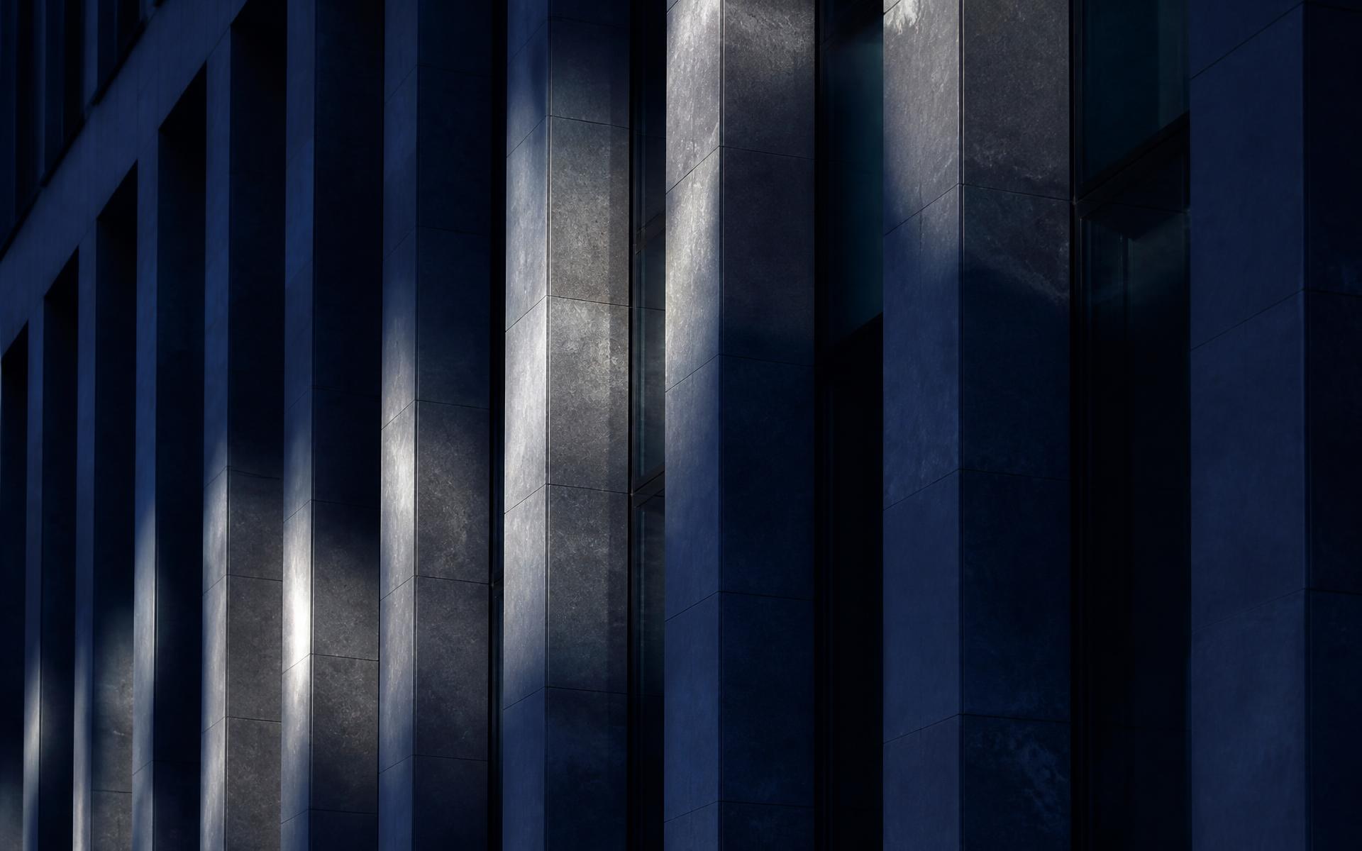 Detail of a contemporary European institutional building facade in low light